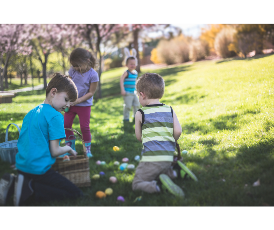 children playing in a park on an Easter egg hunt