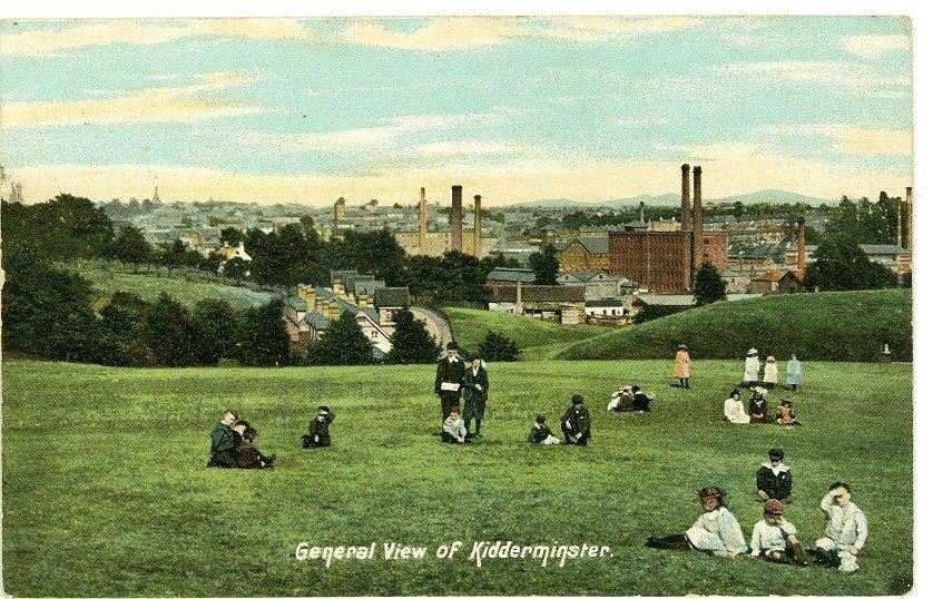 old colour postcard of park with industrial building behind caption read general view of kidderminster